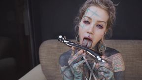 Anuskatzz slides the smooth steel deep, moaning with each slow thrust