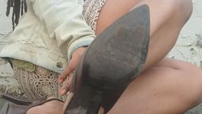 Kicking over emptybeer bottles in brown leather sling back heels