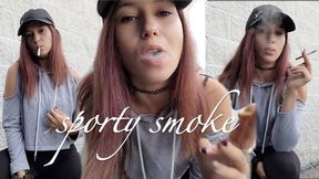 Sporty Looking Girl Smokes a Cigarette