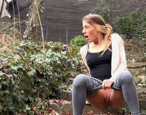 Nice sporty slender girl pulls down her grey yoga pants and pisses