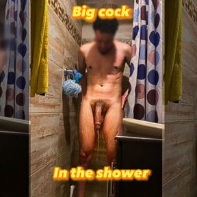 Young man shows his hanging cock in the shower