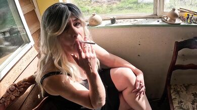 Blonde MILF smokes alone in her tight black dress