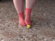 Fat legs in socks ruthlessly trample banana. Crush Fetish, foot fetish.