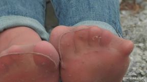 Jeans feet teasing in worned nylon socks outdoor