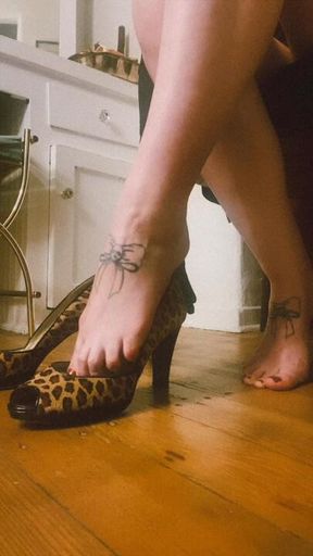 Mistress slips bare feet into stilettos