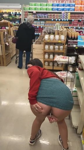 Woman in aisle of grocery store