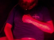 Masturbating illuminated by a deep red light