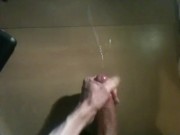 Polishing glans of huge uncut cock and shooting huge load across desk