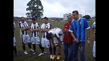 Rodinha de jogadores pegando no pau durante treino.