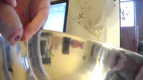 Closeup of John peeing into a steel bowl