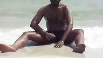 Black amateur jerking his big cock on the beach
