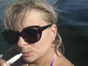 Smoke fetish on beach. Big boobs close up