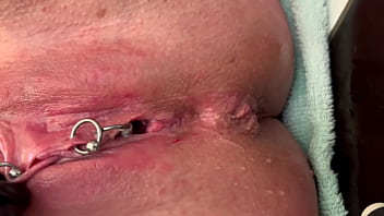 Slick latex gloves rub pierced clit vigorously