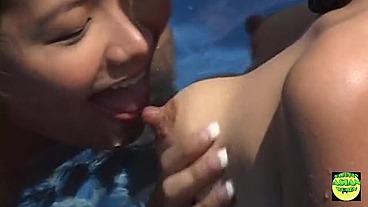 A couple of horny Asian lesbian brunettes lick each other in the pool