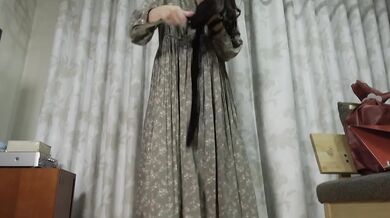 The old maid plays with her long gift dildo in long maid dress