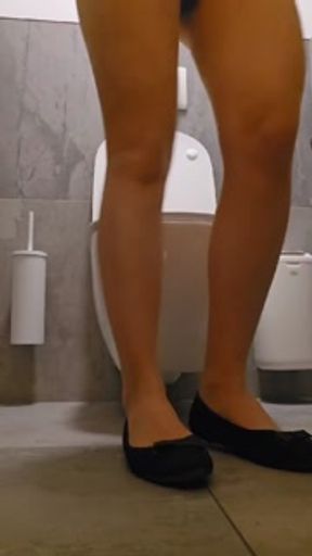 Public toilet pissing in Tights and beautiful dress