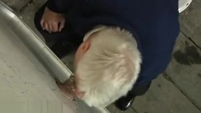 Grey old moustached man giving blowjob through glory hole