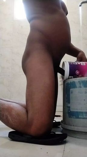 Cex from mug in bucket in bathroom
