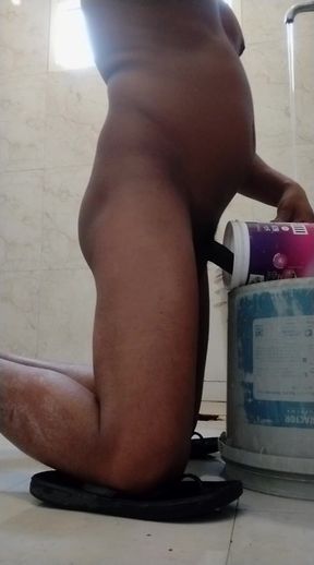 Cex from mug in bucket in bathroom