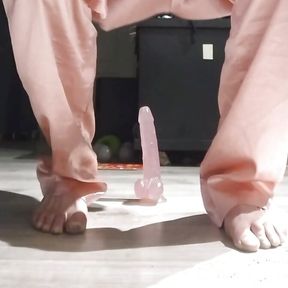 Riding in pink pajamas on a pink dildo.