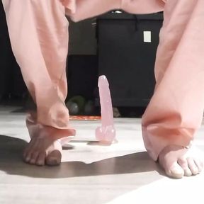 Riding in pink pajamas on a pink dildo.