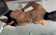 Cyclist with a huge penis showing its bulge in his shorts and urinating heavily.