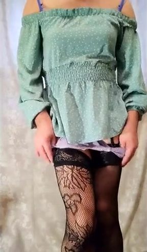 a cross-dresser poses in a short dress and a swimsuit