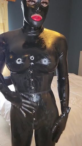 Watch Jessica Doll squeeze into her latex underbust corset, shine herself up and slip on her bondage hood. Can she hold on?