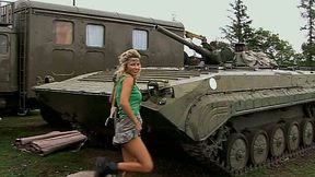 Big tittied blonde hottie strips on a hood on military jeep