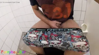 Horny twink jerks off big uncut cock in public restroom