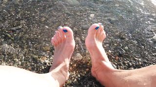 On public beach I sit on the shore dressed in cutoffs and t-t-shirt and drenching my soles in the river ...