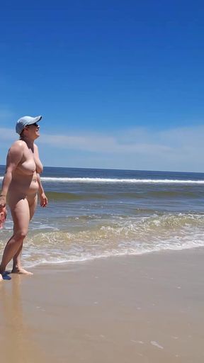 Amateur filming. A nudist plays with waves on the ocean shore.   Clip 1