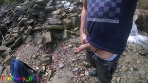 I piss in a mountain stream and then feel like jerking off my cock, despite the risk of getting caught. Outdoor fun in Nature.
