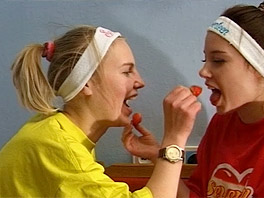Two girls handling some fruit