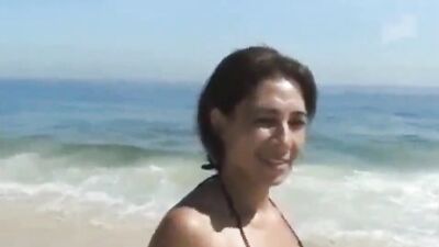 Cougar is having sex with a guy she just met on the beach