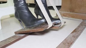 Asian model wearing boots tramples on a piano