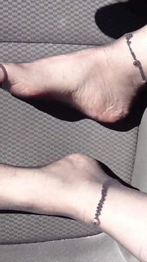 Feet of Nylonjunge in Pantyhose in Car