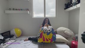 Owllete mouth blows a mid size beach ball