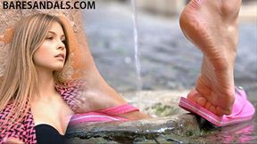 Nora's feet under the fountain water, with sexy pink flip flops - 13523 HD