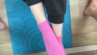 Fitness girl does exercises on the mat in socks and gives a footjob to her trainer with cum on her f