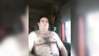Mature trucker daddy strokes his hard cock during a break
