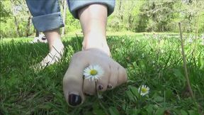Christine tramples, rubs and pull-off grass and flowers with tiny barefoot
