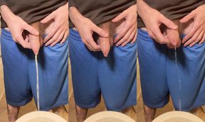 Hairy uncircumcised white guy in gym shorts pissing in the toilet