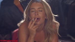 Darcy May chain smoking corks laying on front while talking to you