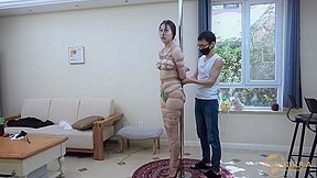 Tied to a pole with dildo gag