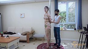 Tied to a pole with dildo gag