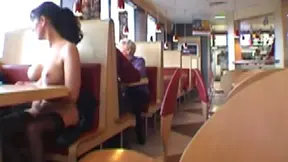 Sexy Brunette Shows Off Her Boobs at Busy Restaurant Table