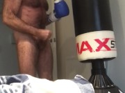 Nude boxer jerk off against heavy bag