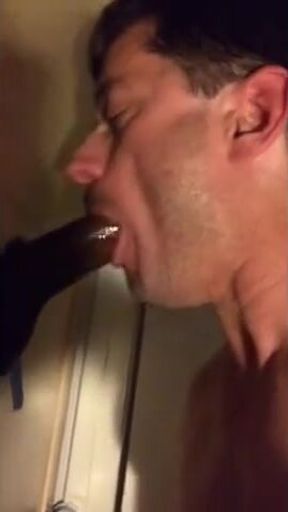 Amateur sucks big black cock at glory hole