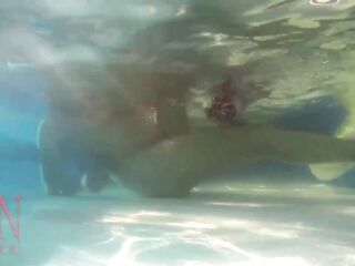 Elegant and flexible hottie, swimming underwater in the outdoor swimming pool. 3 1